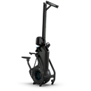 A black vertical ski exercise machine with handlebars, a fan flywheel at the base, and foot platforms, designed for indoor cardio workouts, against a plain white background.